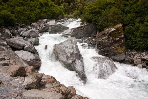 Colorful Rocks in White Water - New Zealand, Mt Aspiring National Park Stock Photos