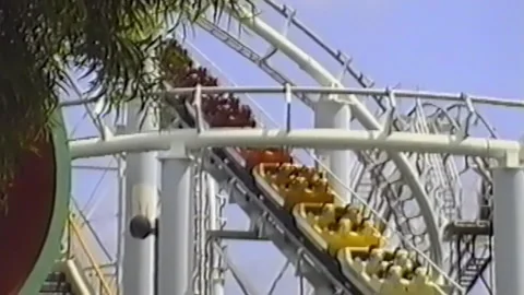 Colorful Roller Coaster Ascends Through White Steel Loops Stock Footage 312509867