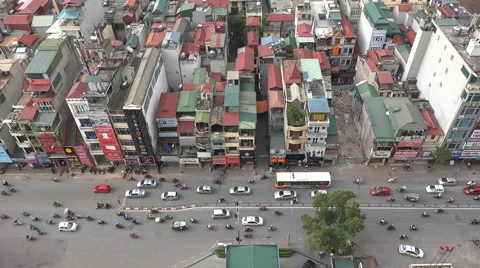 Colorful rooftops, traffic drives through busy streets in Hanoi, Vietnam Видео 60950815