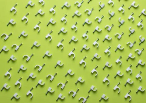 Colorful round cable clamp pattern top view on green background Stock Photos