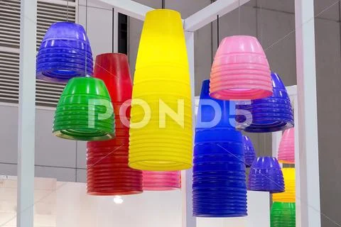 Colorful round stylish lampshades hang from ceiling Stock Photos