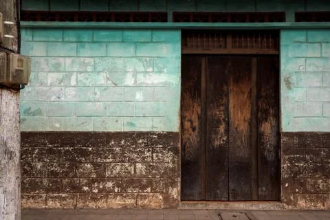 Colorful Run Down Brick Wall Building with Texture on Street Stock Photos