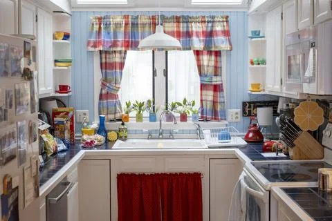 Colorful Rustic Kitchen Interior with White Cabinets and Blue Wood Paneling 写真素材