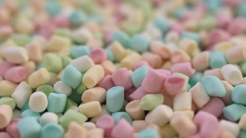 Colorful scattered marshmallows on blurred background with spinning motion Stock Footage 296744367