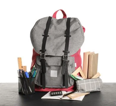 Colorful school backpack with different stationery supplies on black table ag Stock Photos