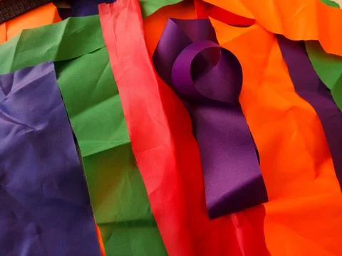 Colorful scraps of fabric in disarray on the table Stock Photos