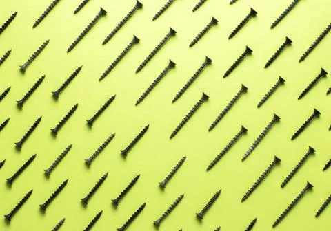 Colorful screw pattern top view on green background 스톡 사진