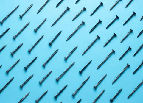 Colorful screw pattern top view on blue background Stock Photos