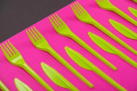 Colorful set of plastic table ware isolated on background Foto stock