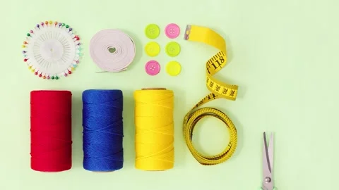 Colorful Sewing Supplies with Thread Spools Buttons Pins and Measuring Tape 動画素材 346080463