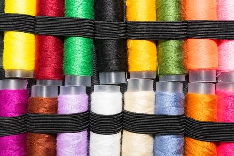 Colorful sewing thread spools in a row close up macro concept for textile Stock Photos