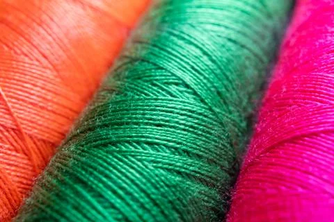 Colorful sewing thread spools in a row close up macro concept for textile Stock Photos