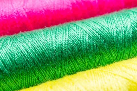 Colorful sewing thread spools in a row close up macro concept for textile Stock Photos