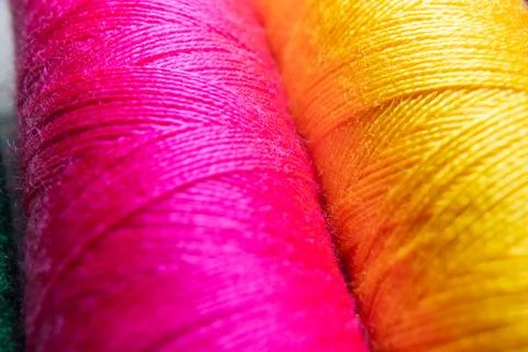 Colorful sewing thread spools in a row close up macro concept for textile Stock Photos