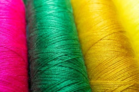 Colorful sewing thread spools in a row close up macro concept for textile Stock Photos