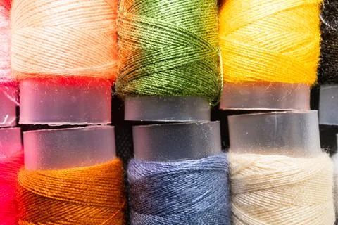 Colorful sewing thread spools in a row close up macro concept for textile Stock Photos