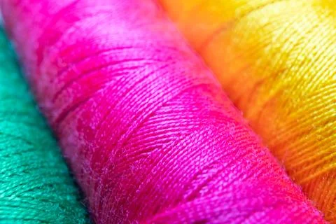 Colorful sewing thread spools in a row close up macro concept for textile Stock Photos