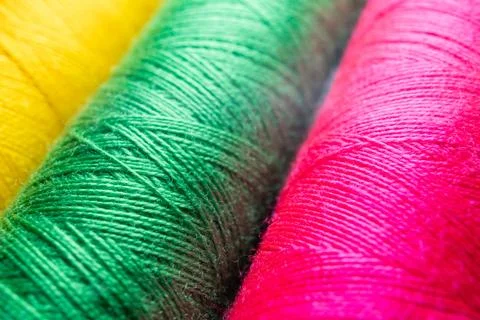 Colorful sewing thread spools in a row close up macro concept for textile Stock Photos