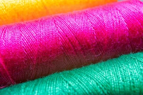 Colorful sewing thread spools in a row close up macro concept for textile Stock Photos