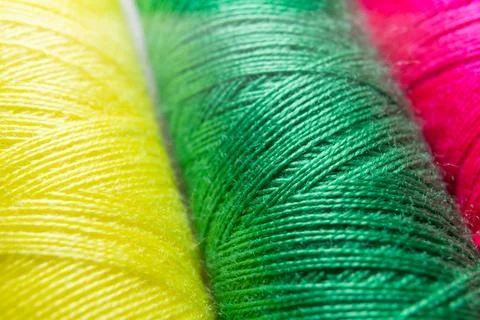 Colorful sewing thread spools in a row close up macro concept for textile Stock Photos