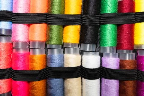 Colorful sewing thread spools in a row close up macro concept for textile Stock Photos