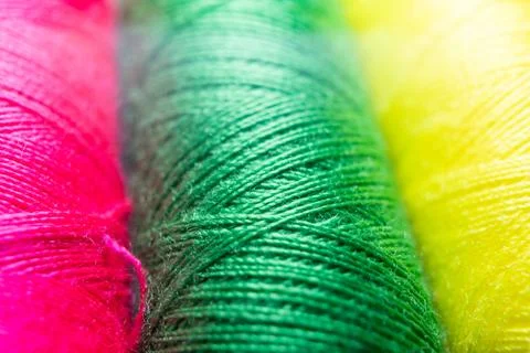 Colorful sewing thread spools in a row close up macro concept for textile Stock Photos