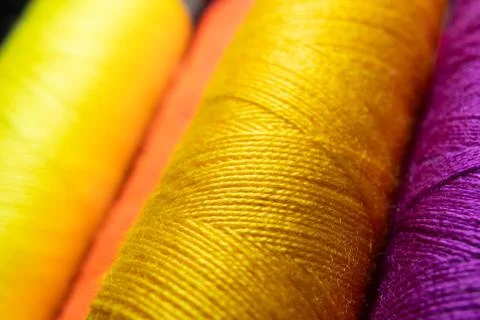 Colorful sewing thread spools in a row close up macro concept for textile Stock Photos