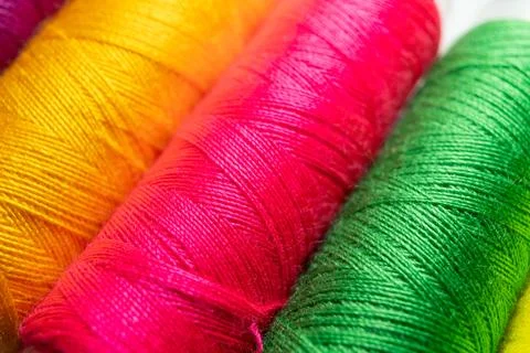 Colorful sewing thread spools in a row close up macro concept for textile Stock Photos