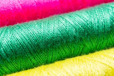 Colorful sewing thread spools in a row close up macro concept for textile Stock Photos