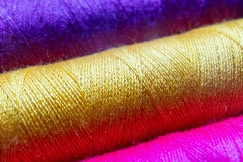 Colorful sewing thread spools in a row close up macro concept for textile Stock Photos