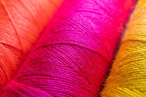 Colorful sewing thread spools in a row close up macro concept for textile Stock Photos