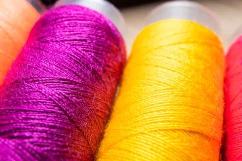 Colorful sewing thread spools in a row close up macro concept for textile Stock Photos
