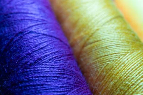 Colorful sewing thread spools in a row close up macro concept for textile Stock Photos