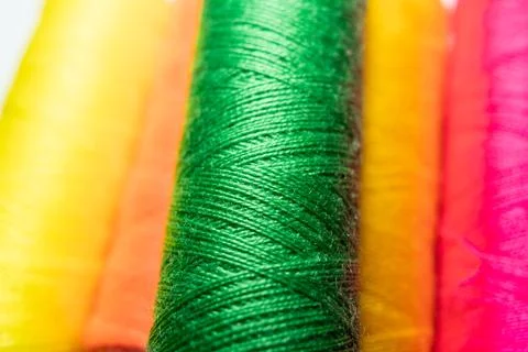 Colorful sewing thread spools in a row close up macro concept for textile Stock Photos