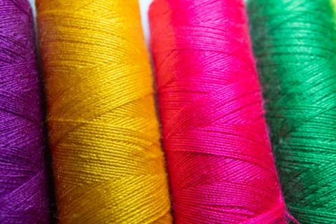 Colorful sewing thread spools in a row close up macro concept for textile Stock Photos