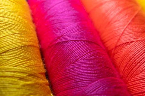 Colorful sewing thread spools in a row close up macro concept for textile Stock Photos