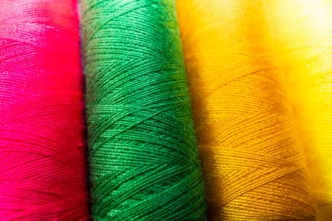 Colorful sewing thread spools in a row close up macro concept for textile Stock Photos