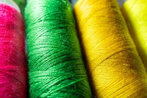 Colorful sewing thread spools in a row close up macro concept for textile Stock Photos