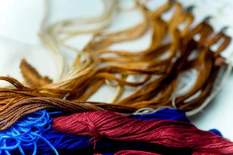 Colorful sewing thread on a white table Stock Photos