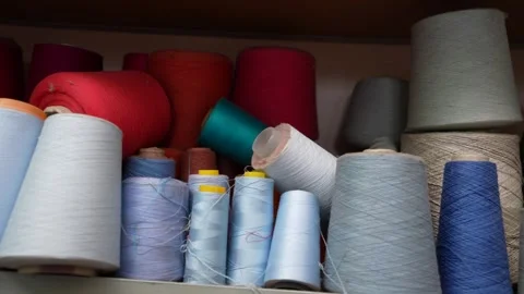 Colorful sewing threads and vibrant textile yarns used for knitting various Stock Footage 334436302