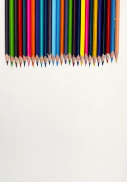 Colorful sharpened pencils are lined up on the table. Stock Photos