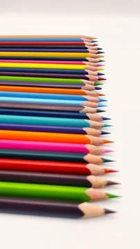 Colorful sharpened pencils are lined up on the table. Stock Photos