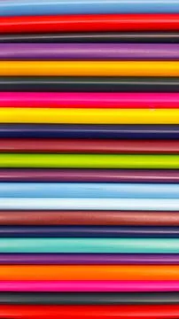 Colorful sharpened pencils are lined up on the table. Stock Photos