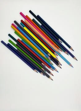 Colorful sharpened pencils are lined up on the table. Stock Photos