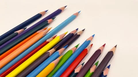 Colorful sharpened pencils are lined up on the table. Stock Photos