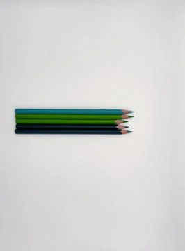 Colorful sharpened pencils are lined up on the table. Stock Photos