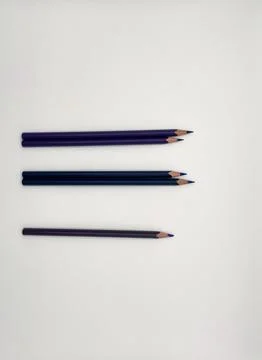 Colorful sharpened pencils are lined up on the table. Stock Photos