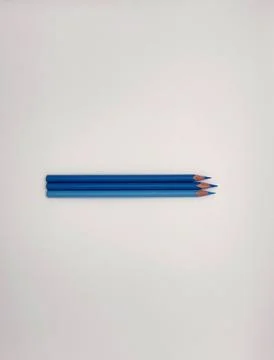 Colorful sharpened pencils are lined up on the table. Stock Photos