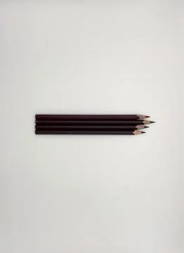Colorful sharpened pencils are lined up on the table. Stock Photos