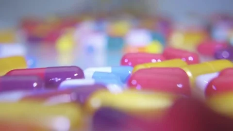 Colorful shining capsules rolling into the camera Stock Footage 82680026